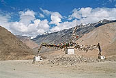 Ladakh - pile of stones on  mountain pass with the characteristc prayer flags